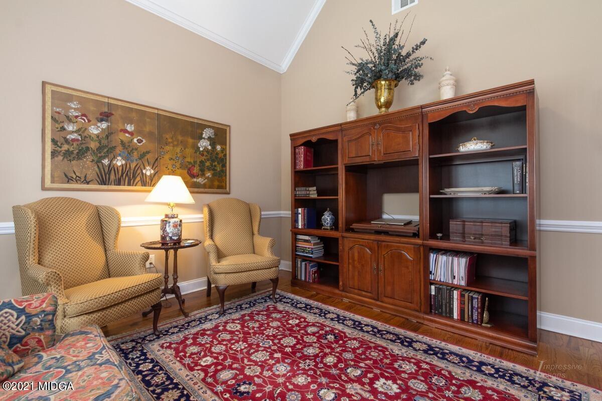 7109 Colaparchee Road Macon, GA 31220 - Photo 12 of 34 a living room with furniture and a book shelf