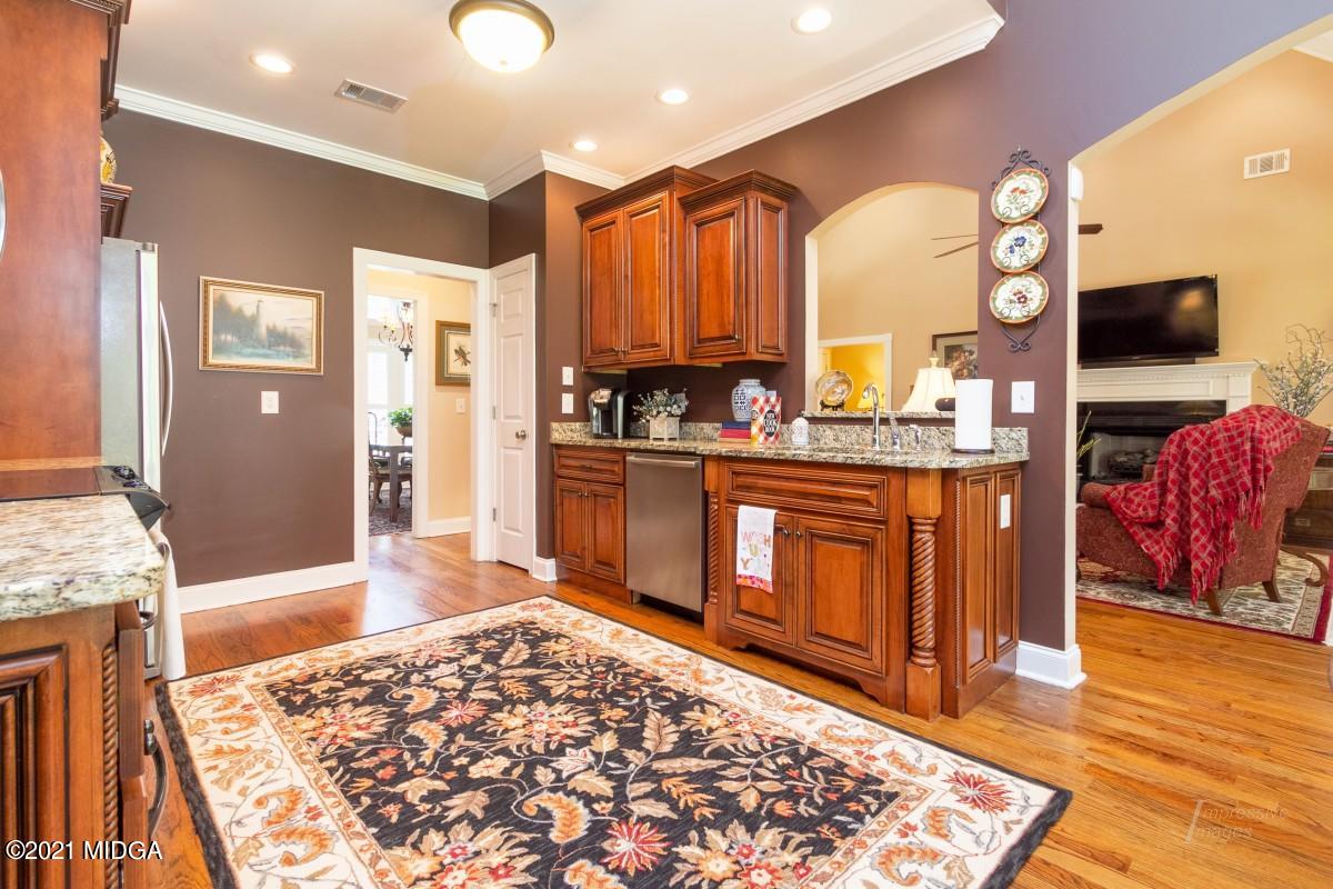 7109 Colaparchee Road Macon, GA 31220 - Photo 13 of 34 a living room with stainless steel appliances furniture a rug and a kitchen view