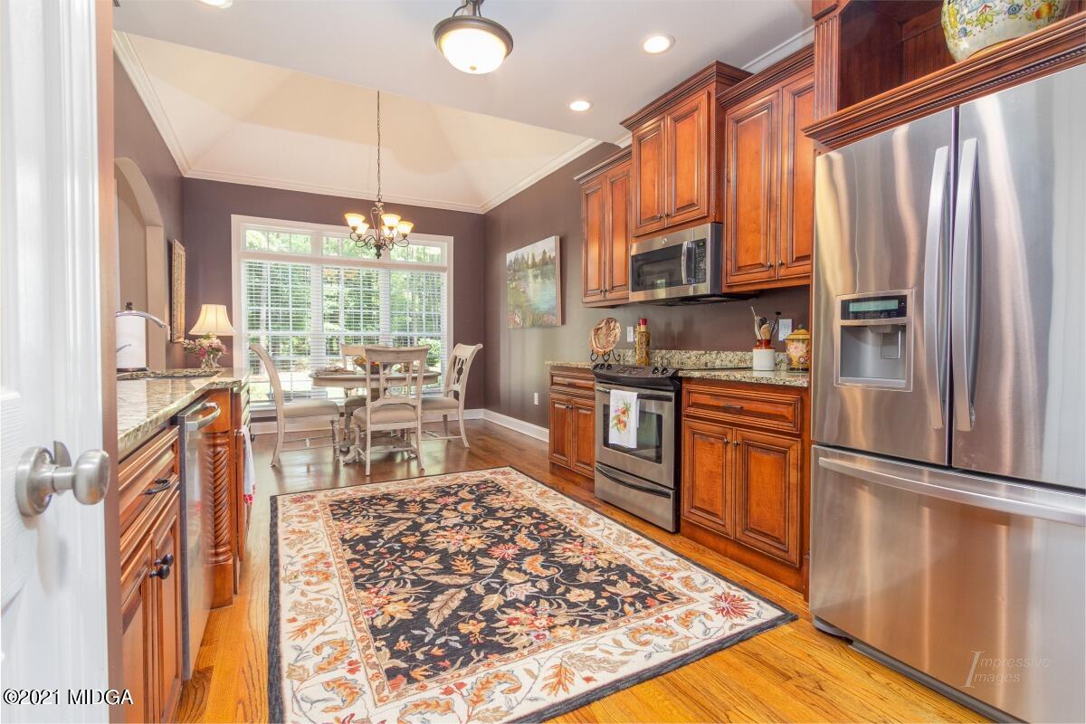 7109 Colaparchee Road Macon, GA 31220 - Photo 14 of 34 a kitchen with stainless steel appliances granite countertop a refrigerator stove top oven dining table and chairs