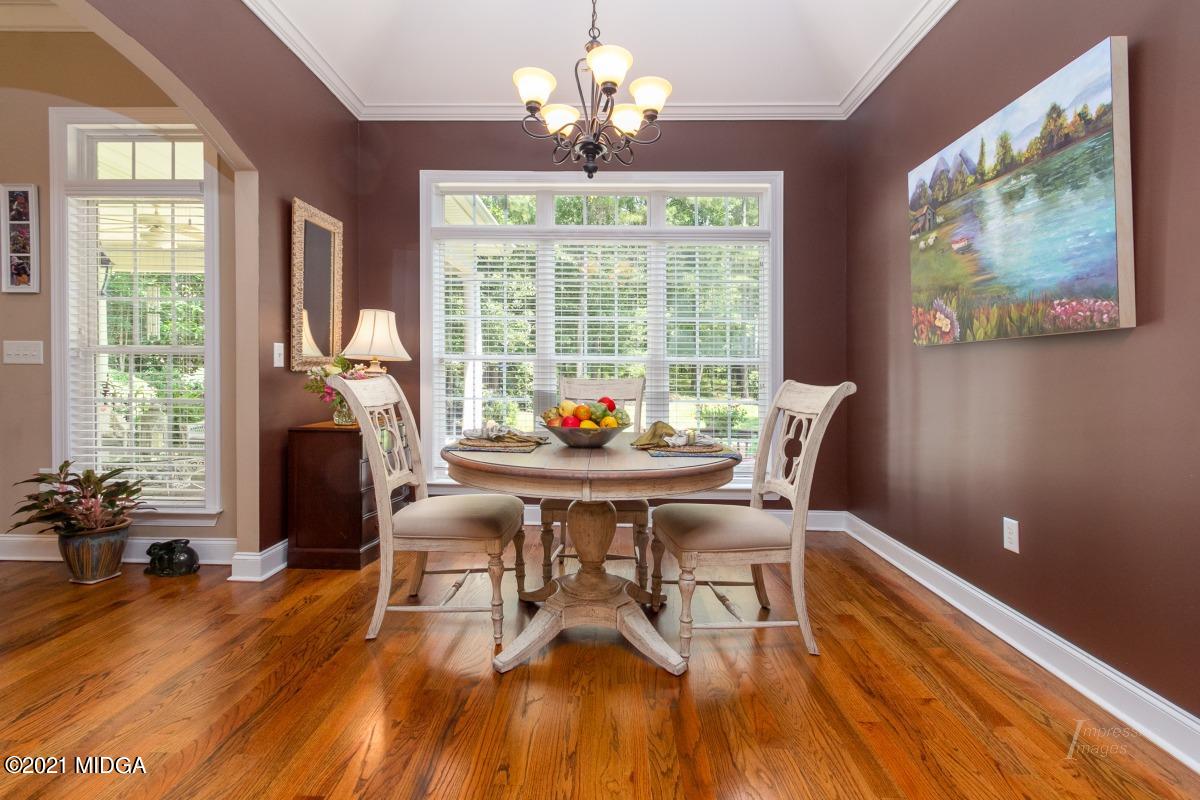 7109 Colaparchee Road Macon, GA 31220 - Photo 16 of 34 a view of a dining room with furniture a chandelier and wooden floor