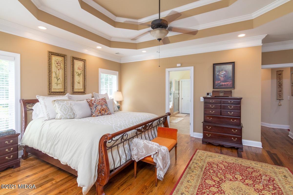 7109 Colaparchee Road Macon, GA 31220 - Photo 18 of 34 a bedroom with a bed a dresser and a chandelier