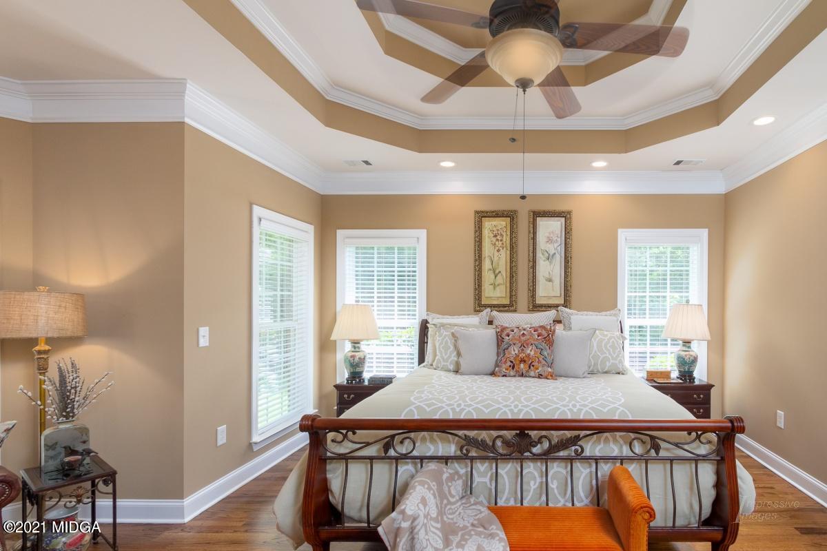 7109 Colaparchee Road Macon, GA 31220 - Photo 19 of 34 a bedroom with a bed and a chandelier