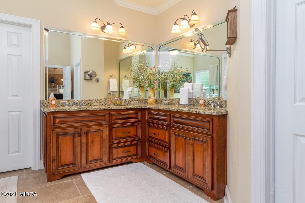 7109 Colaparchee Road Macon, GA 31220 - Photo 20 of 34 a bathroom with a granite countertop sink and a mirror