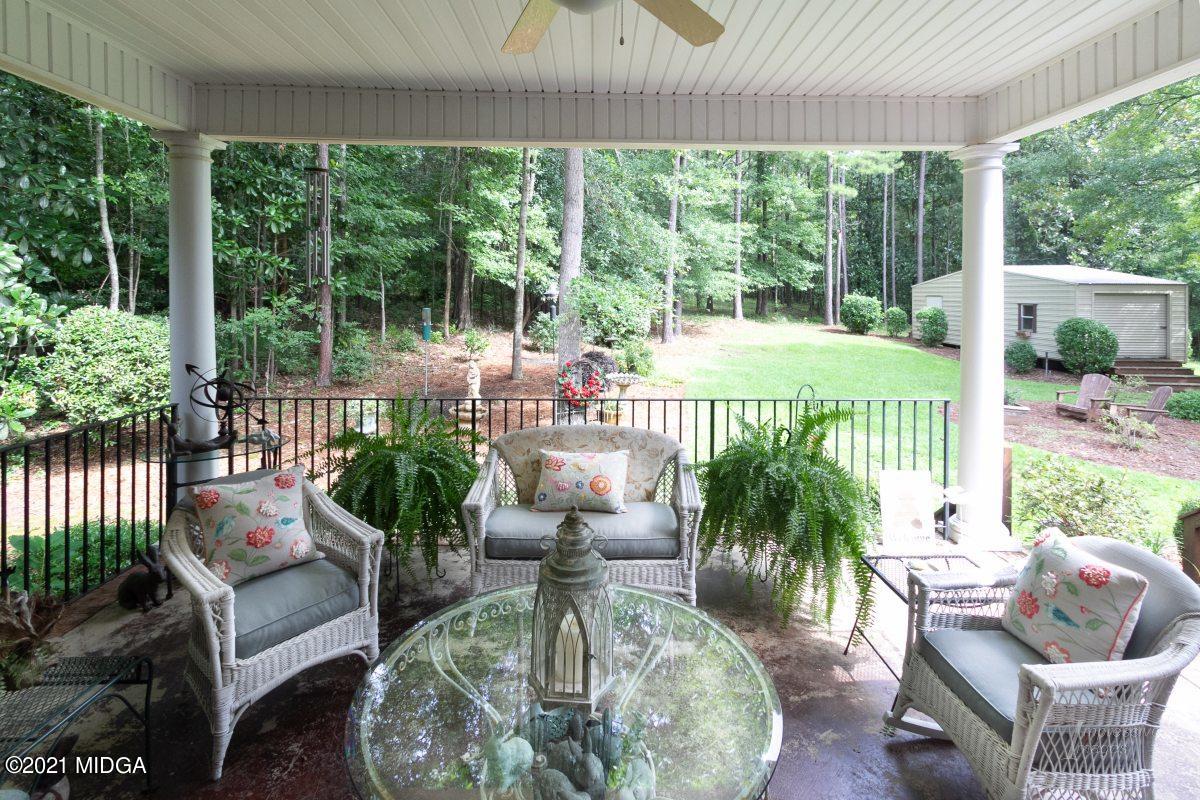 7109 Colaparchee Road Macon, GA 31220 - Photo 32 of 34 a view of a patio with couches chairs and potted plants