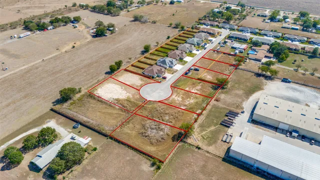 an aerial view of a residential houses with outdoor space