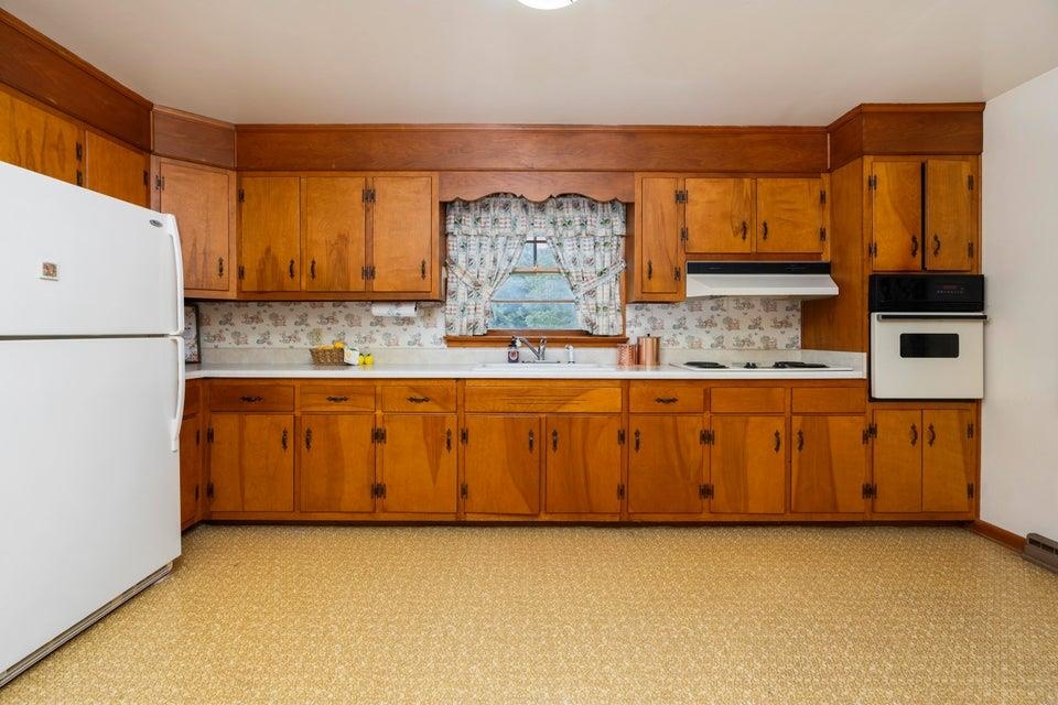48 Round Hill School Road Fort Defiance, VA 24437 - Photo 11 of 37 a kitchen with stainless steel appliances granite countertop a stove a sink and a refrigerator