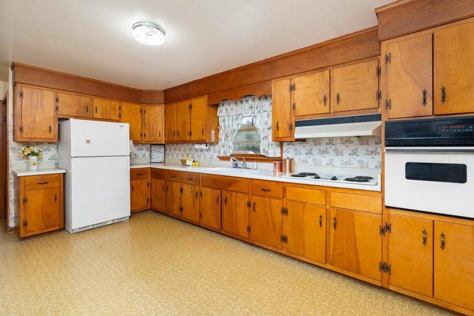 48 Round Hill School Road Fort Defiance, VA 24437 - Photo 12 of 37 a kitchen with a refrigerator a sink dishwasher and cabinets with wooden floor