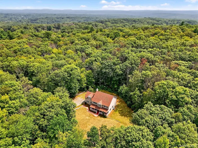 an aerial view of a house with a yard