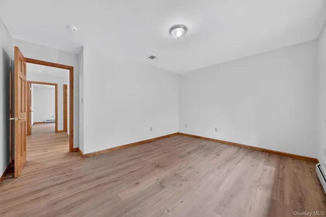 a view of a room with wooden floor