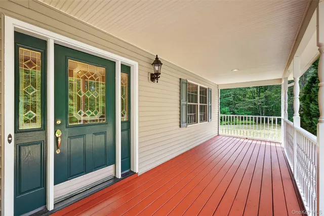 a view of backyard with a large window and wooden floor