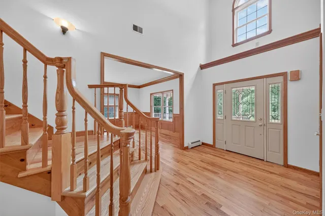 a view of entryway with wooden floor and stairs