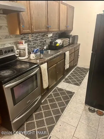 a kitchen with a stove a sink and a microwave