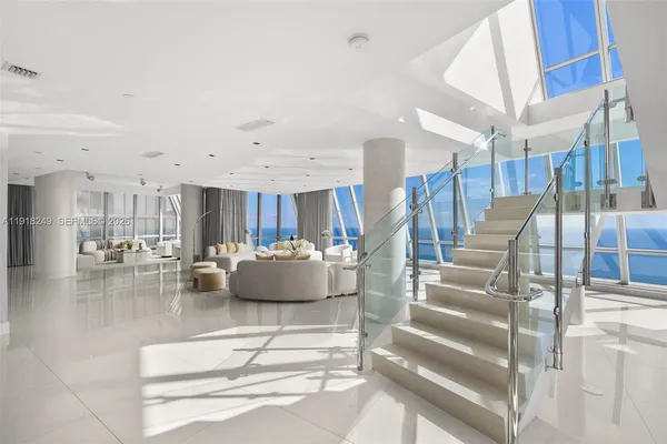 a living room with lots of furniture and a chandelier