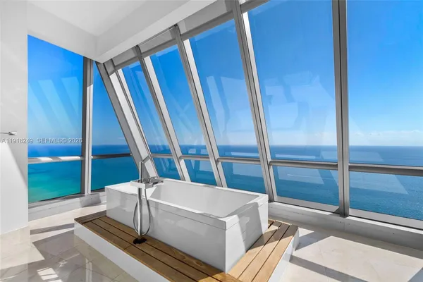 a living room with a balcony and furniture