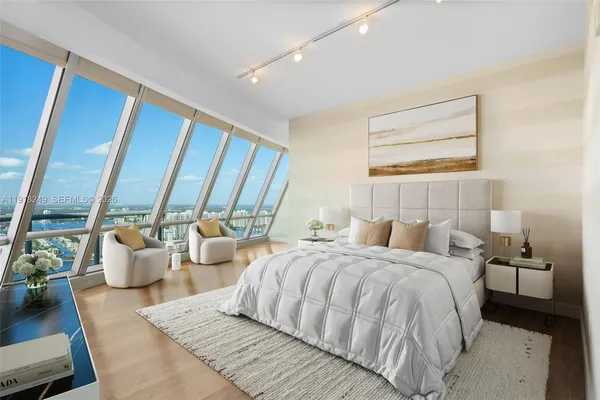 a bed room with two bed and a large window