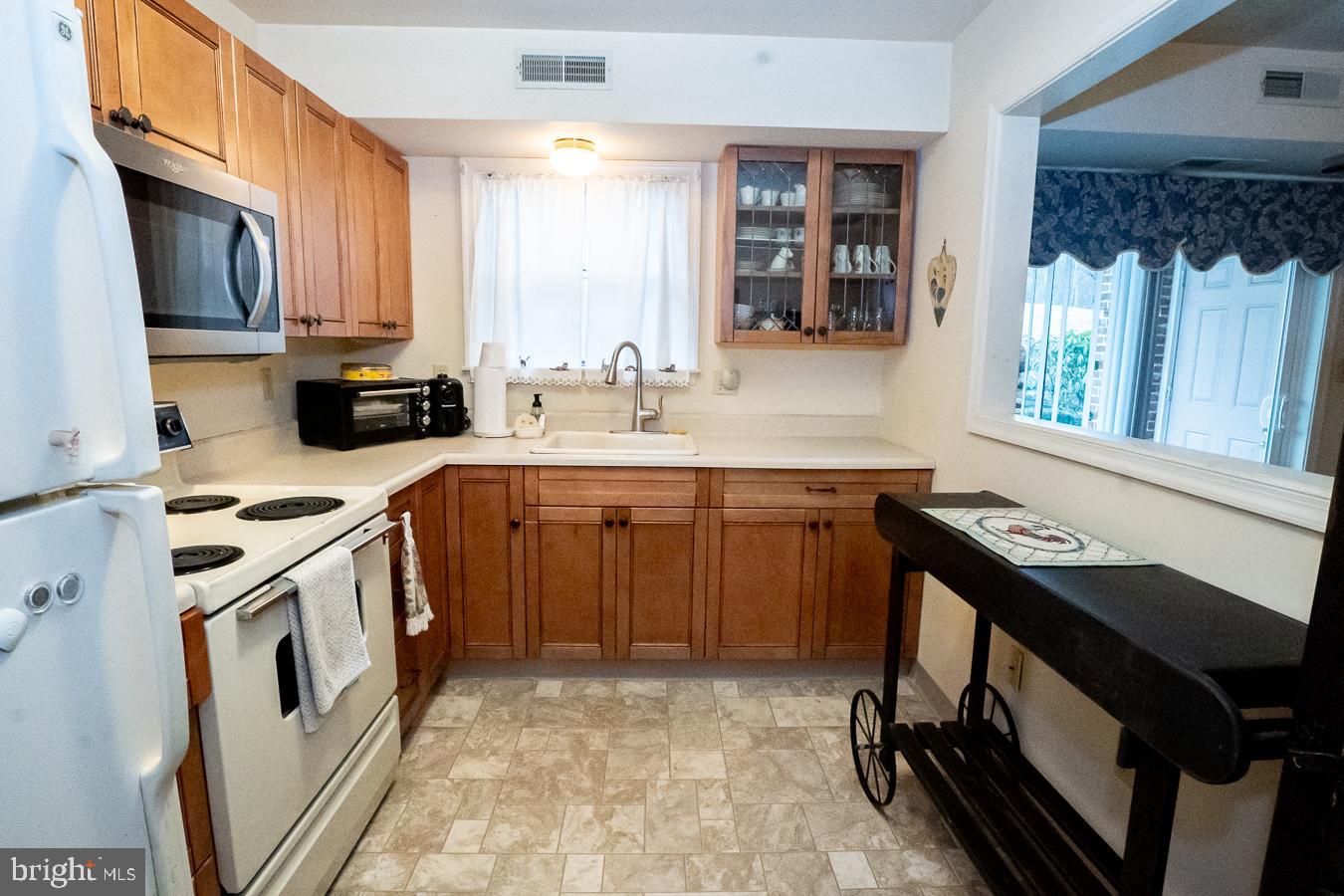 620 Manatawny Street, Unit CONDO 25 Pottstown, PA 19464 - Photo 12 of 28 a kitchen with a sink stove and cabinets