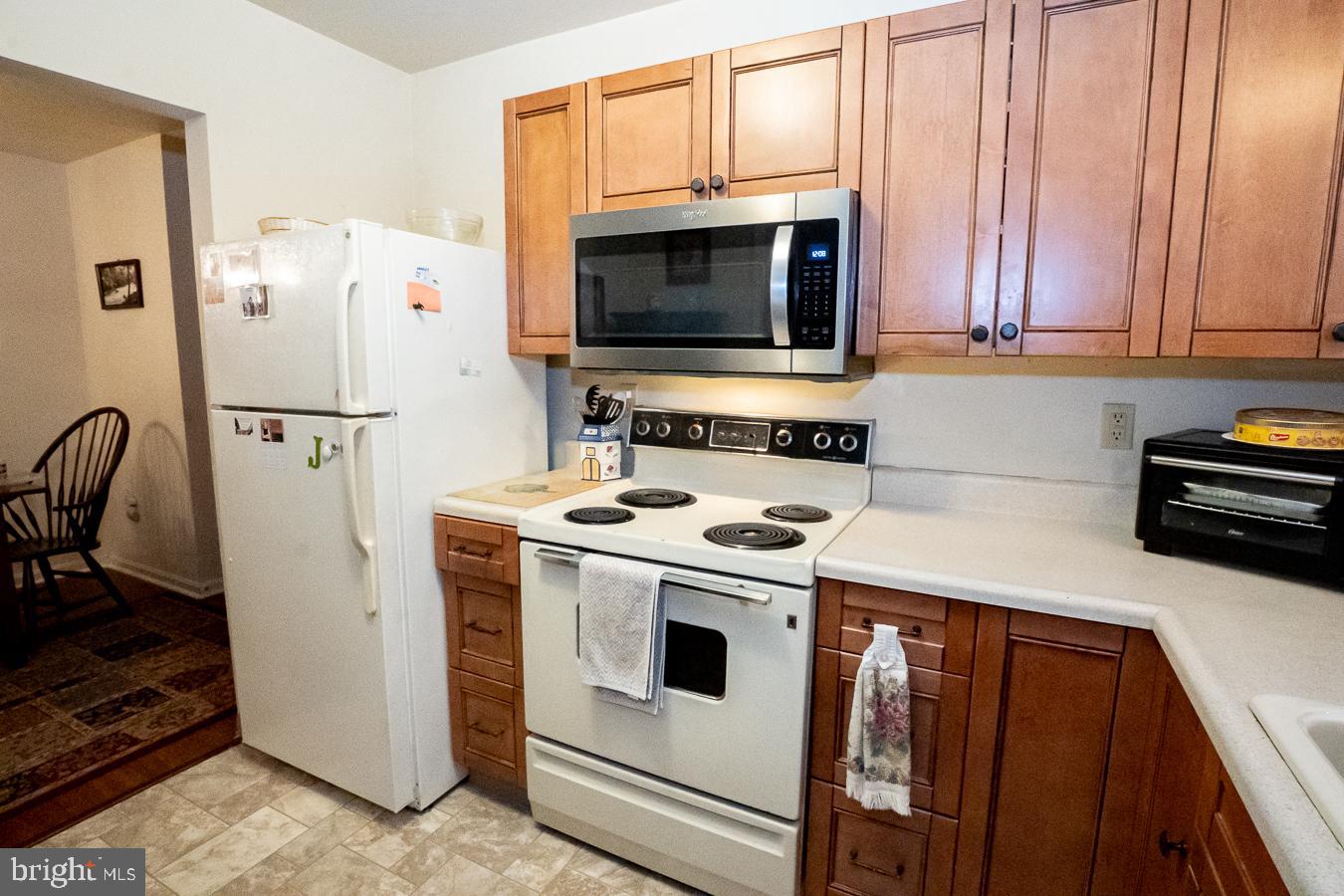 620 Manatawny Street, Unit CONDO 25 Pottstown, PA 19464 - Photo 14 of 28 a kitchen with stainless steel appliances a stove microwave and refrigerator
