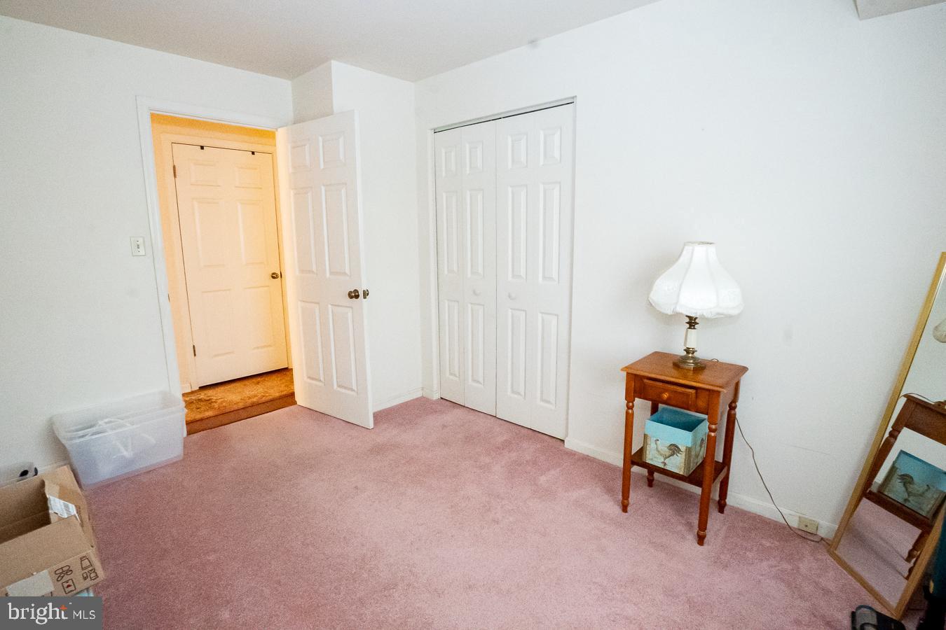 620 Manatawny Street, Unit CONDO 25 Pottstown, PA 19464 - Photo 16 of 28 a bedroom with a bed and a chandelier