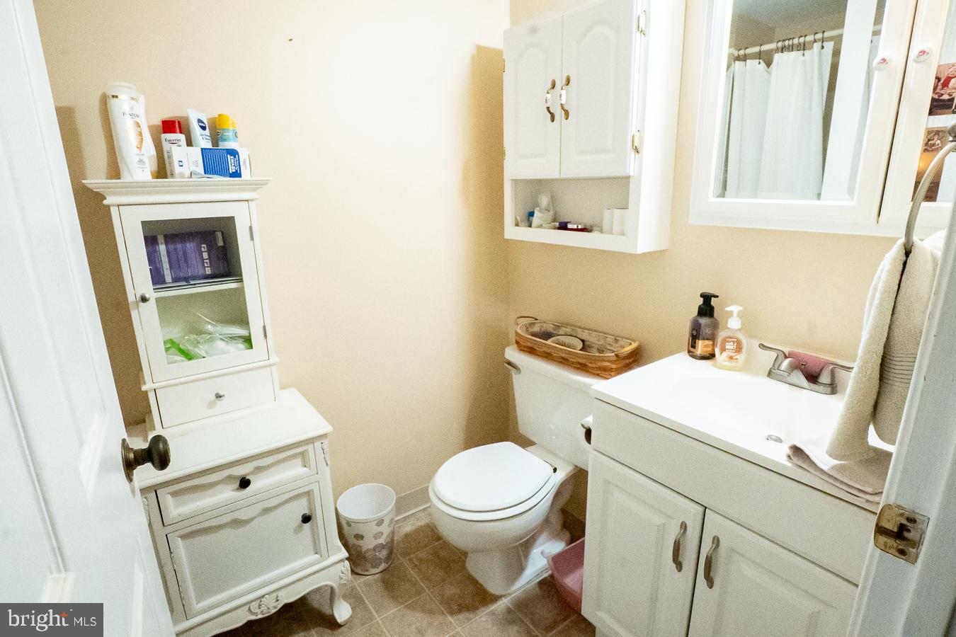 620 Manatawny Street, Unit CONDO 25 Pottstown, PA 19464 - Photo 26 of 28 a bathroom with a toilet sink and mirror