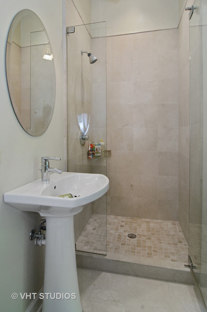 2017 North Sedgwick Street Chicago, IL 60614 - Photo 16 of 30 a bathroom with a sink a mirror and a shower