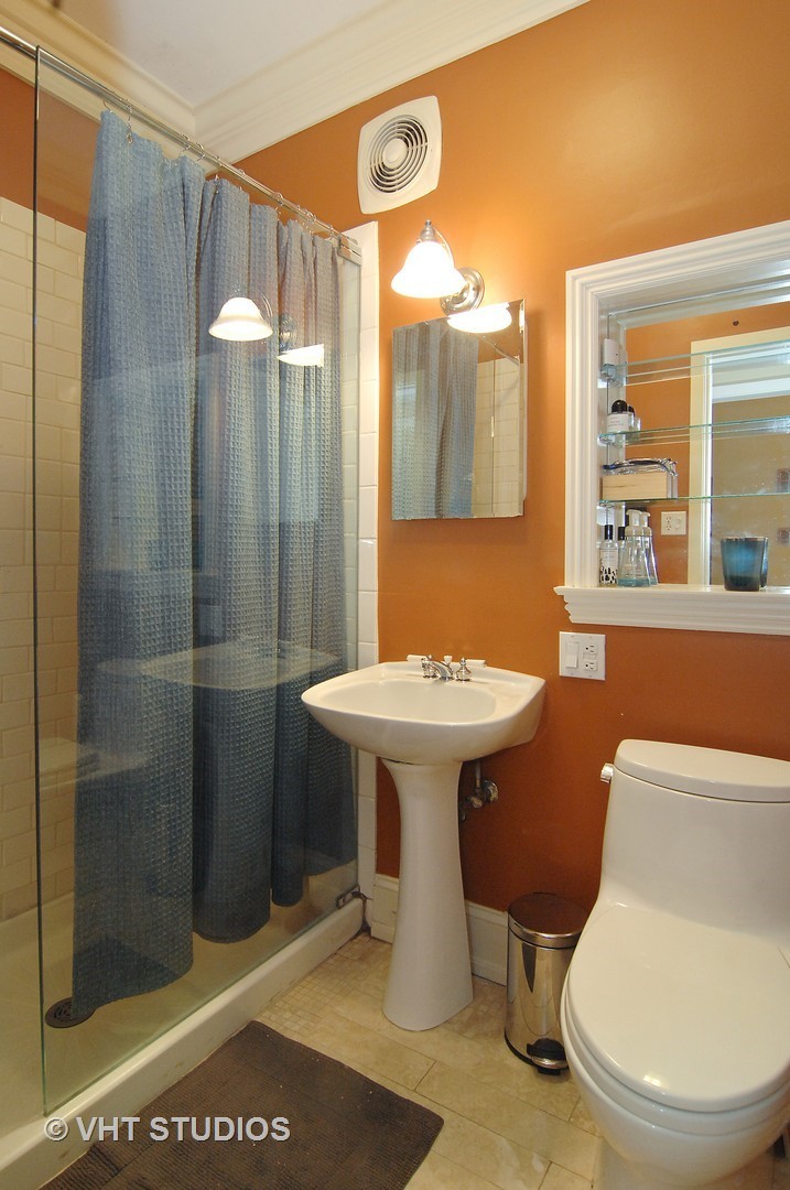 2017 North Sedgwick Street Chicago, IL 60614 - Photo 22 of 30 a bathroom with a sink a toilet a mirror and shower
