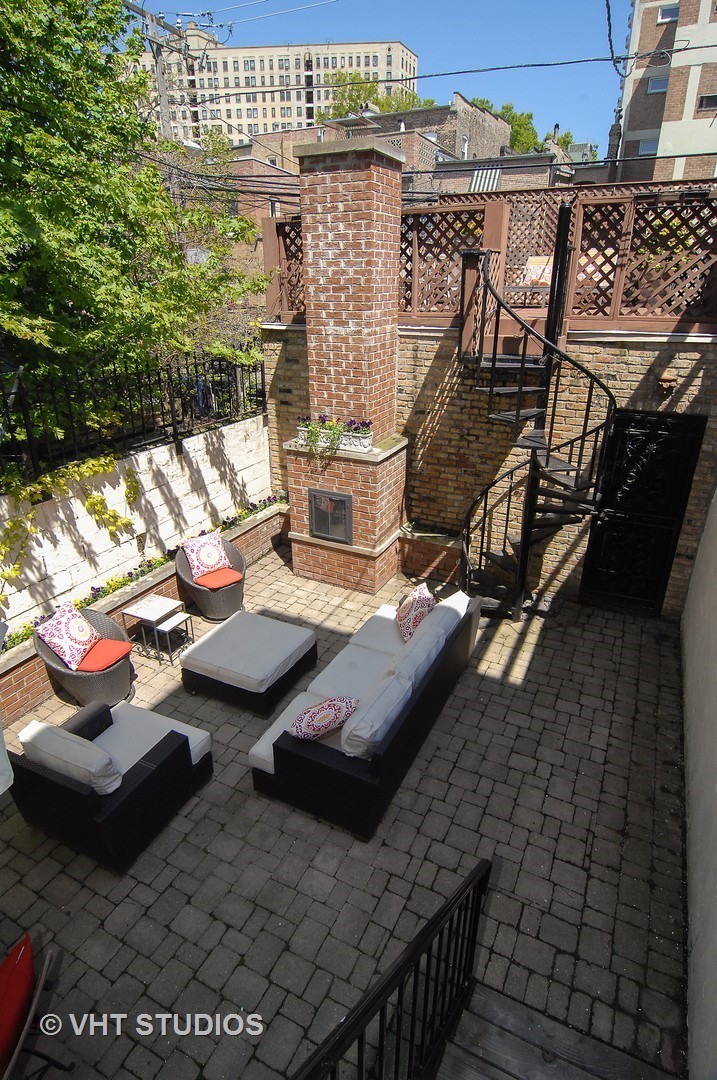 2017 North Sedgwick Street Chicago, IL 60614 - Photo 30 of 30 a view of a balcony with chairs and wooden floor
