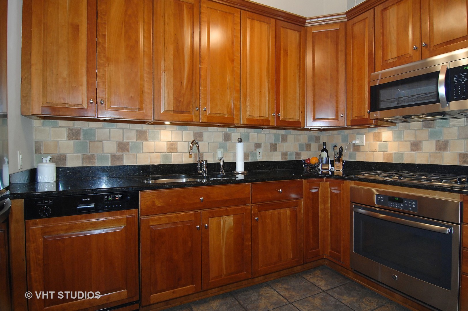 2017 North Sedgwick Street Chicago, IL 60614 - Photo 8 of 30 a kitchen with granite countertop wooden cabinets and stainless steel appliances