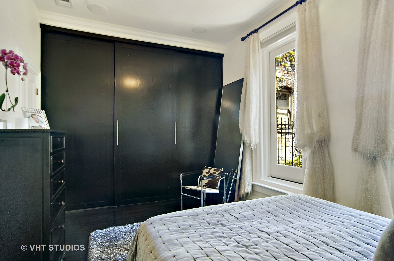 2017 North Sedgwick Street Chicago, IL 60614 - Photo 10 of 30 a bedroom with a bed and a dresser in it
