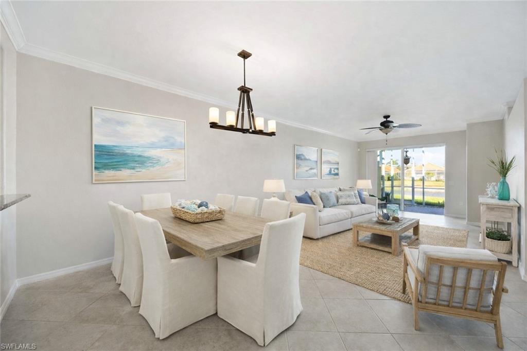 a living room with furniture a chandelier and a dining table