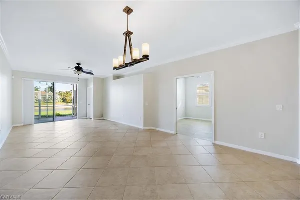 a view of a livingroom with a ceiling fan and entryway