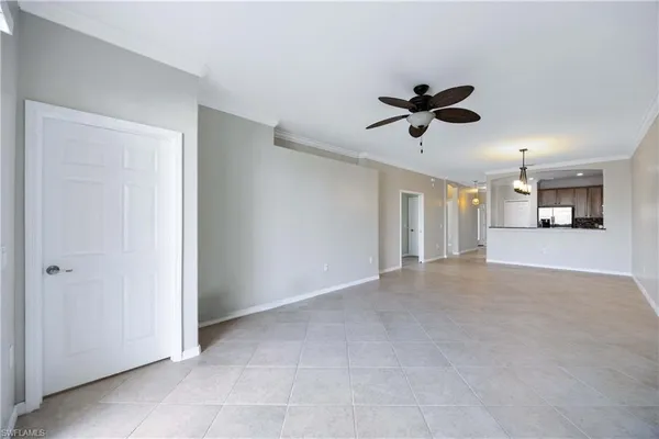 en empty room with ceiling fan and window