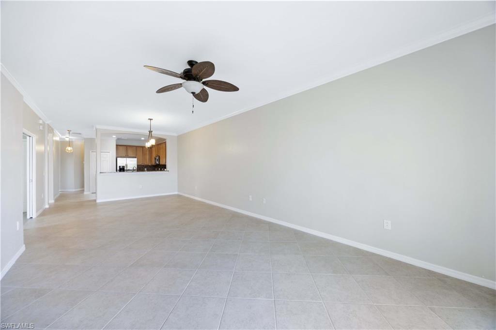 14488 Grapevine Drive Naples, FL 34114 - Photo 13 of 36 en empty room with ceiling fan and window