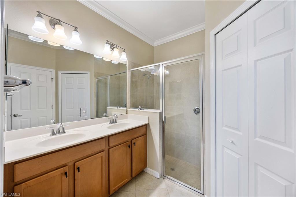 14488 Grapevine Drive Naples, FL 34114 - Photo 15 of 36 a bathroom with a double vanity sink mirror and shower