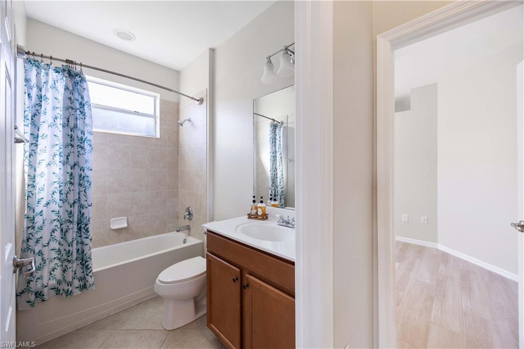 14488 Grapevine Drive Naples, FL 34114 - Photo 17 of 36 a bathroom with a sink a toilet and shower