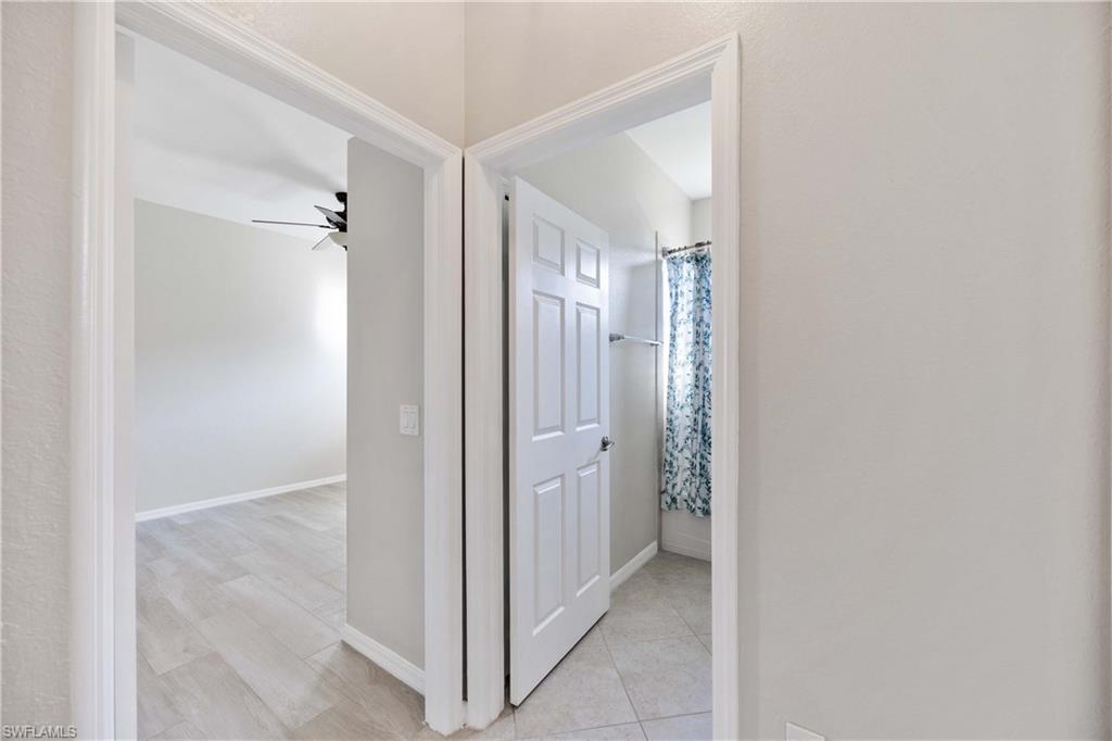 14488 Grapevine Drive Naples, FL 34114 - Photo 18 of 36 a view of a bathroom from a hallway