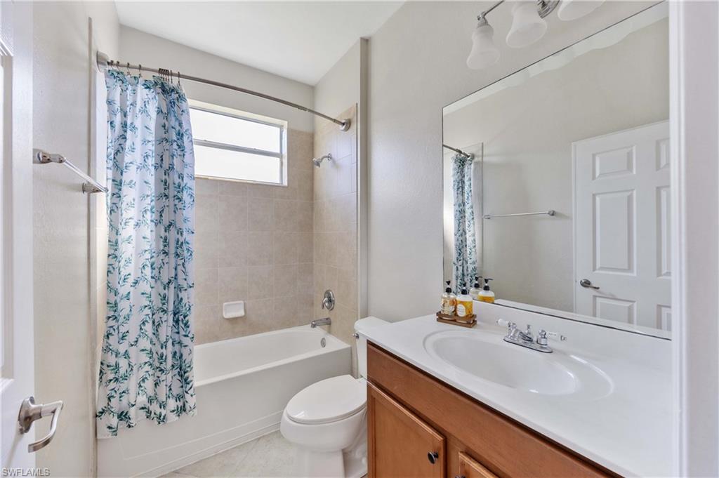 14488 Grapevine Drive Naples, FL 34114 - Photo 19 of 36 a bathroom with a sink toilet a mirror and shower