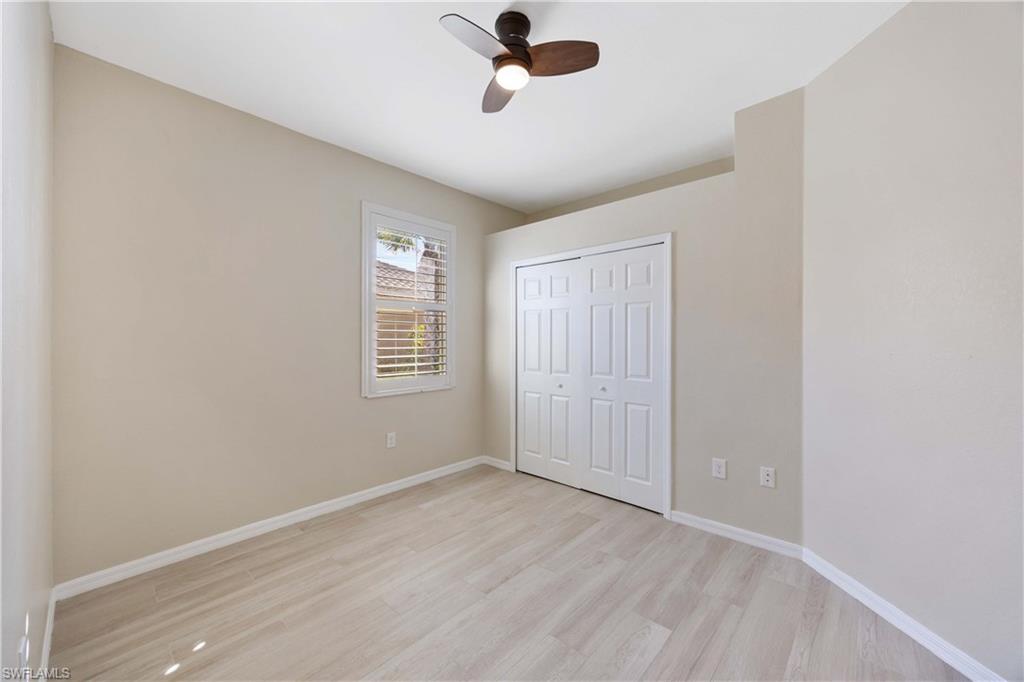 14488 Grapevine Drive Naples, FL 34114 - Photo 20 of 36 an empty room with windows and fan