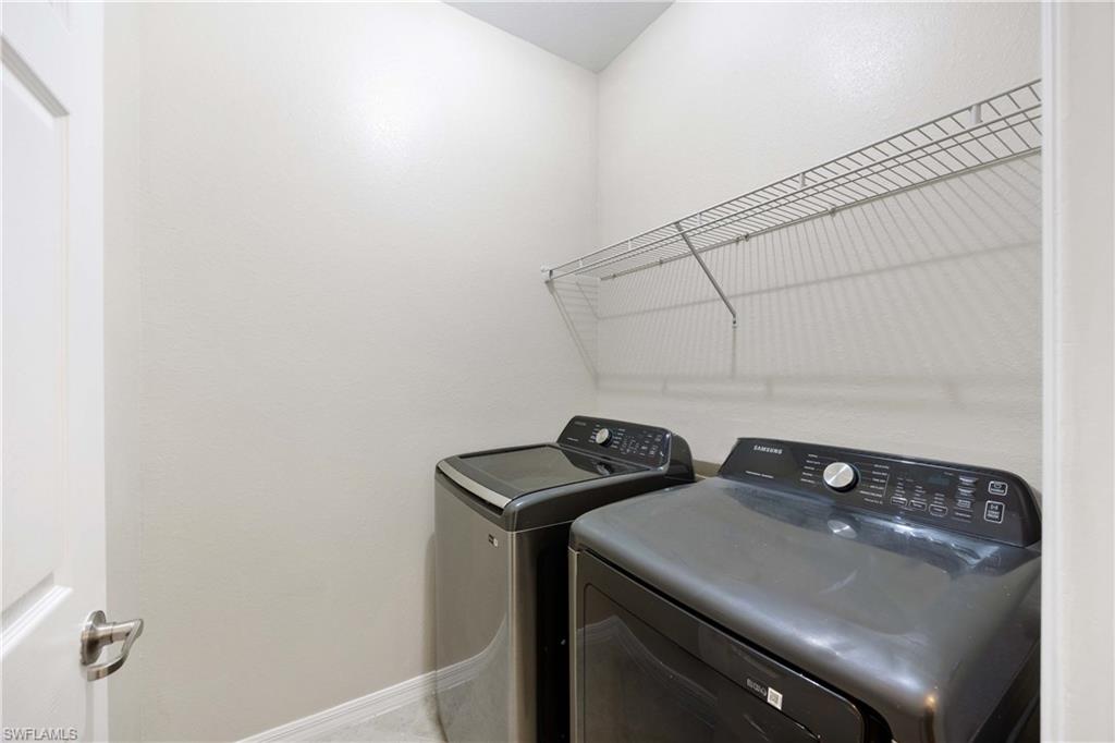 14488 Grapevine Drive Naples, FL 34114 - Photo 21 of 36 a utility room with dryer and washer