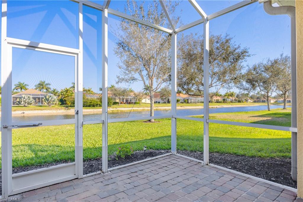 14488 Grapevine Drive Naples, FL 34114 - Photo 22 of 36 a view of a porch with a floor to ceiling window and yard