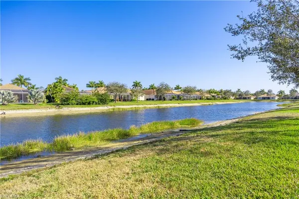 a front view of a house with a yard and potted plants