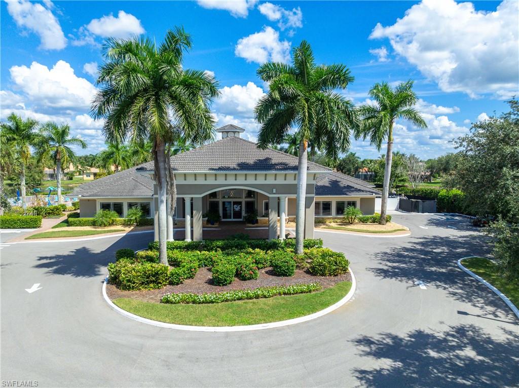 14488 Grapevine Drive Naples, FL 34114 - Photo 25 of 36 a front view of a house with a yard and potted plants