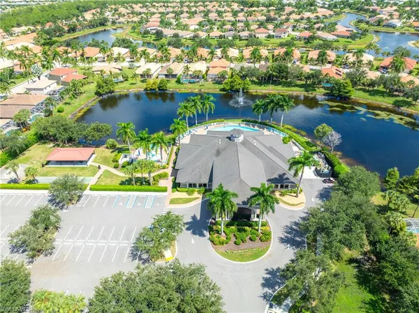 an aerial view of a house with swimming pool and outdoor seating
