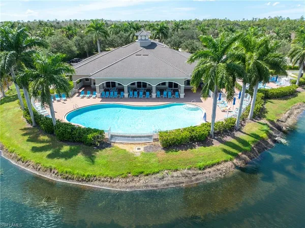 a view of a house with swimming pool and sitting area