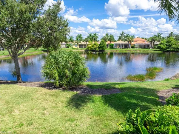 a view of a lake with houses in the back