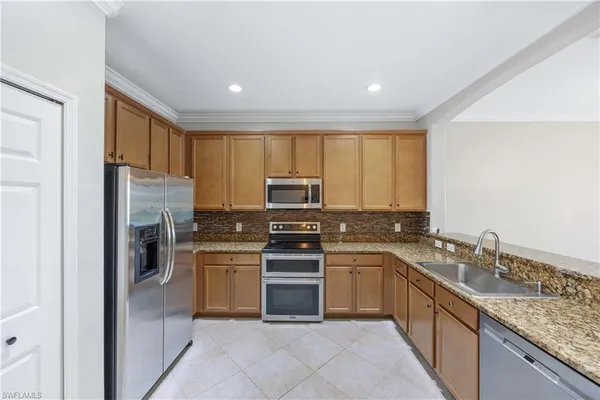 a kitchen with a sink stove and refrigerator