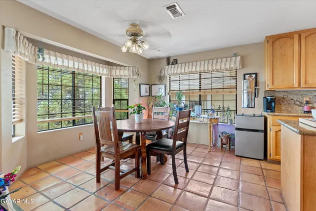 a kitchen with stainless steel appliances granite countertop a refrigerator sink and stove