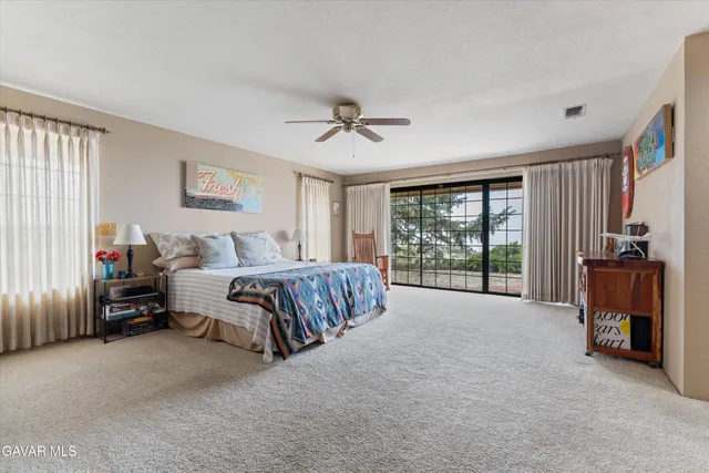 a bathroom with a granite countertop sink a mirror and a bathtub