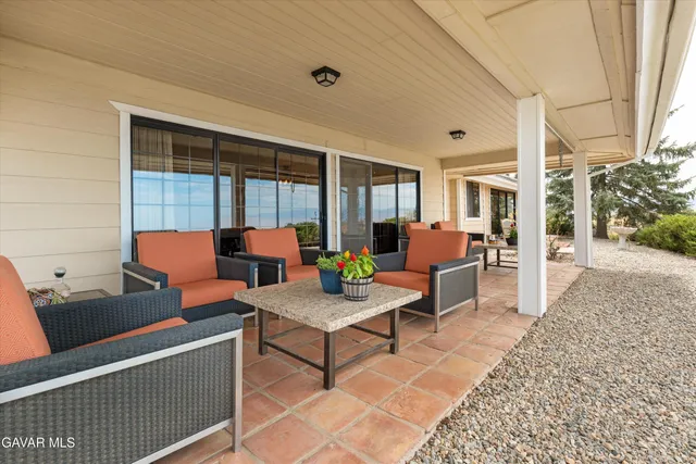a view of a patio with couches chairs and barbeque grill