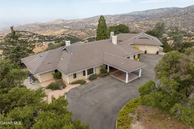 an aerial view of a house with a yard and garage