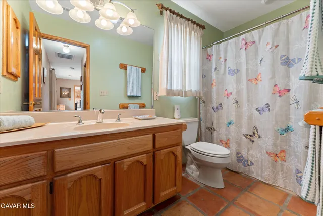 an aerial view of a house with a yard and lake view